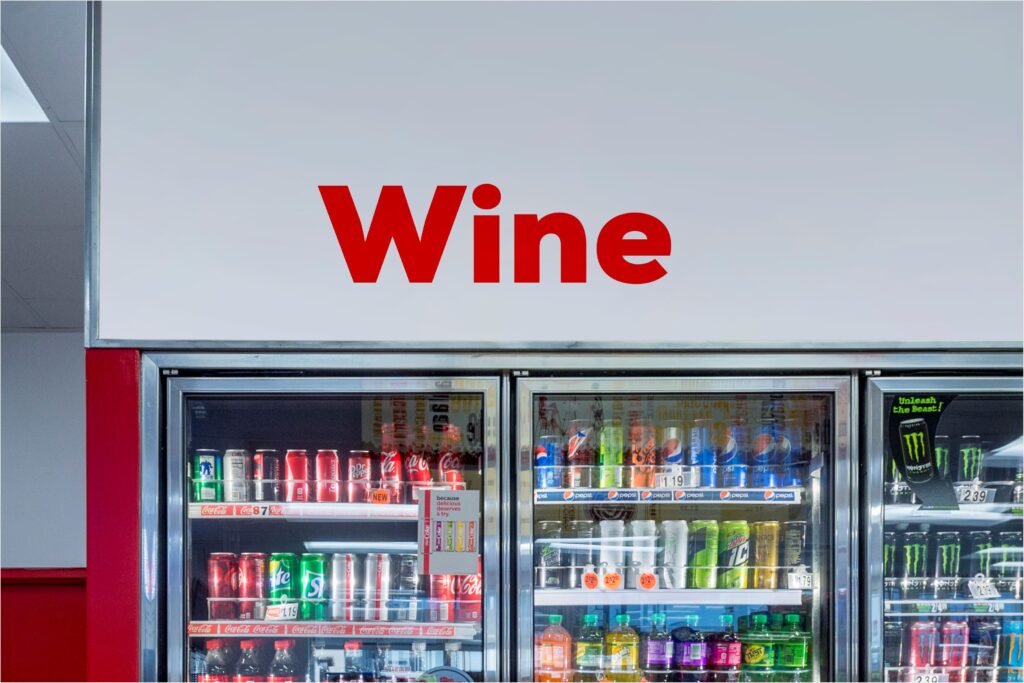Red sign above refrigerated wine cooler.