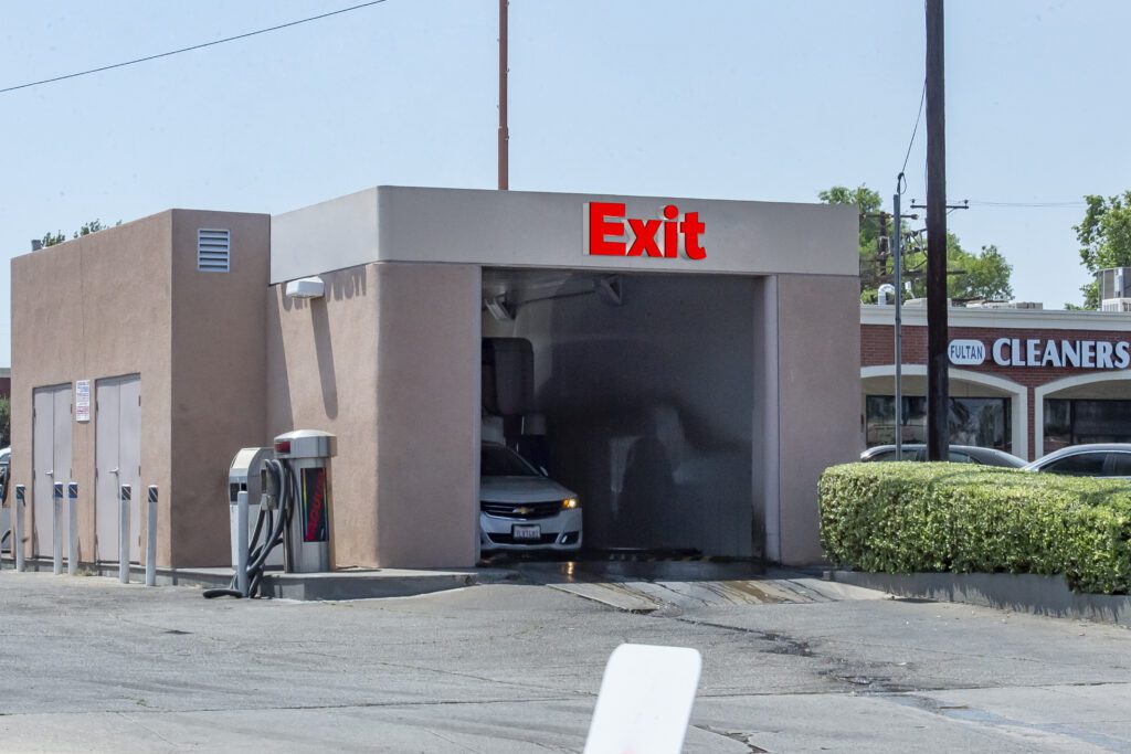 Car wash exit, white car exiting.
