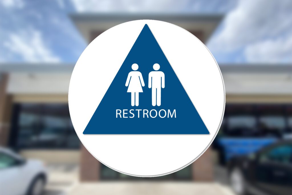 Restroom sign: male and female symbols.