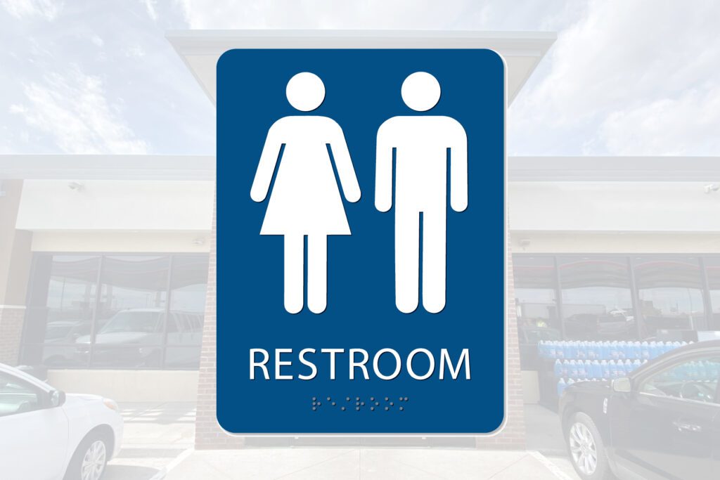 Restroom sign: male and female symbols.