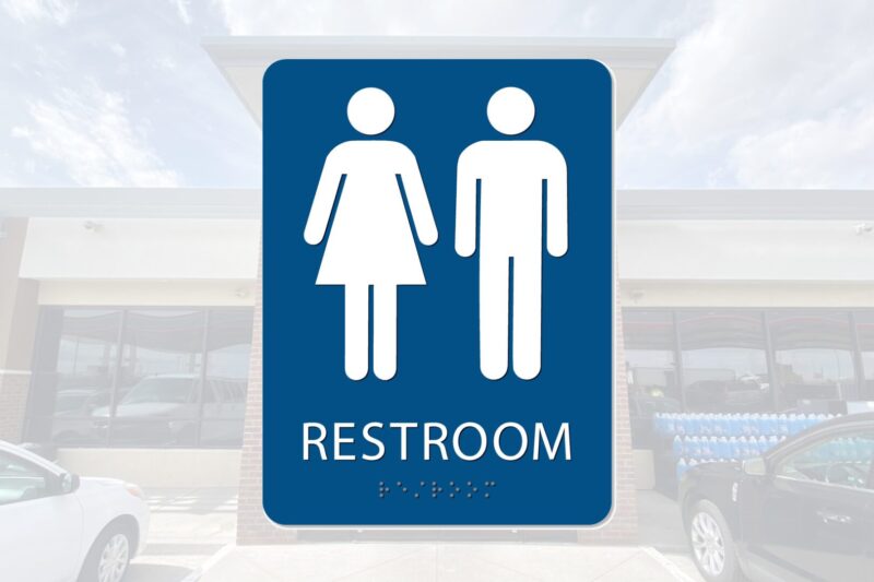 Restroom sign: male and female symbols.