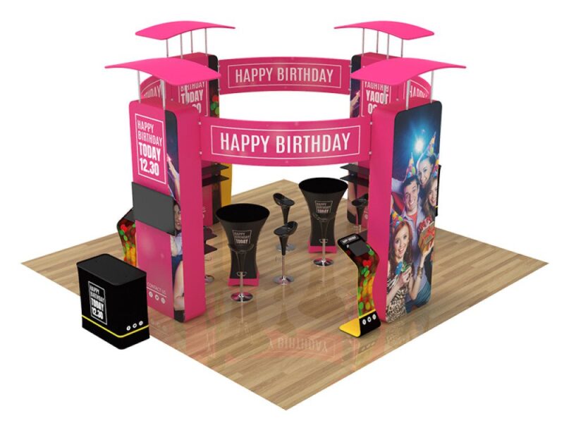 Pink birthday party booth with tables.